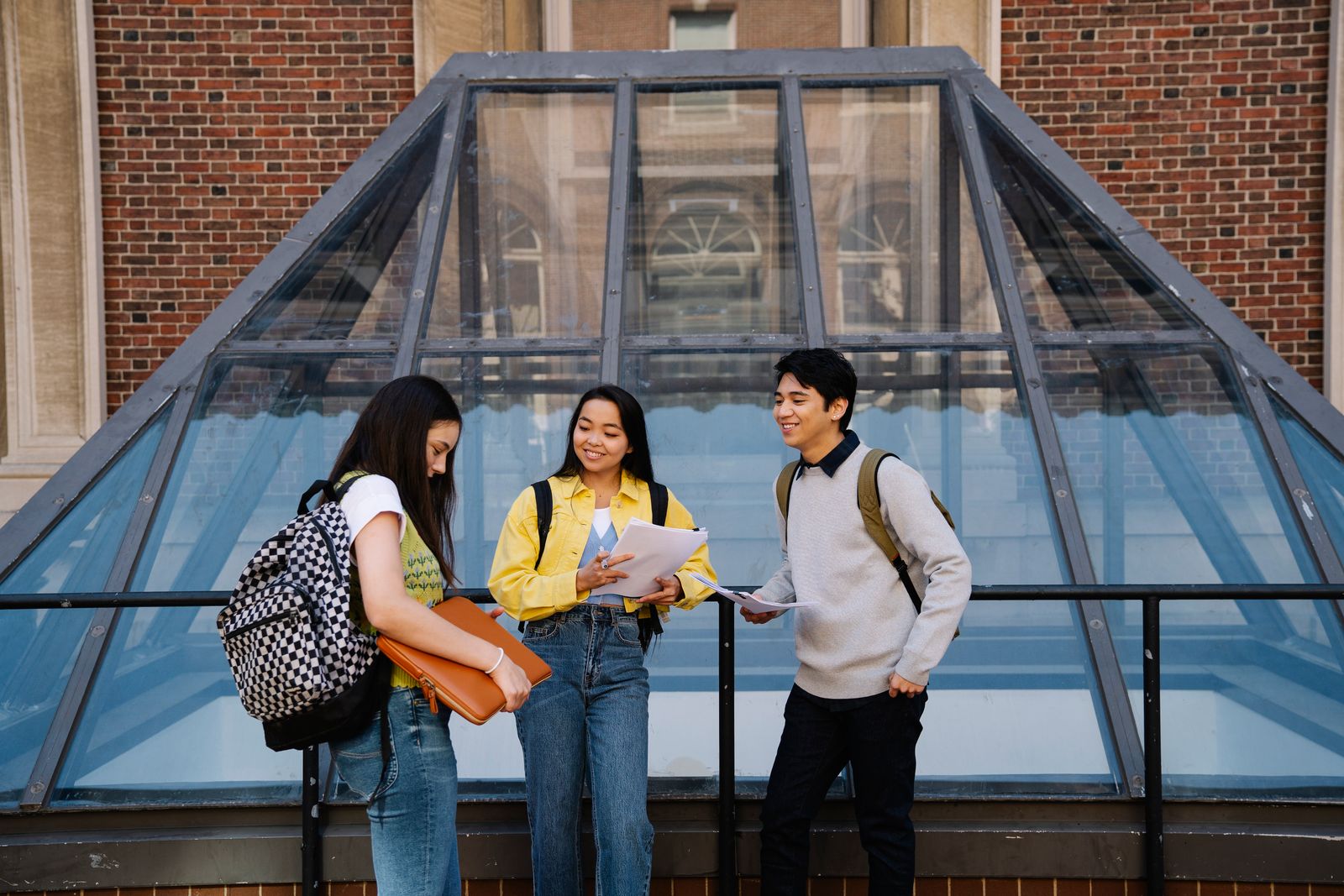 Three students standing together in conversation